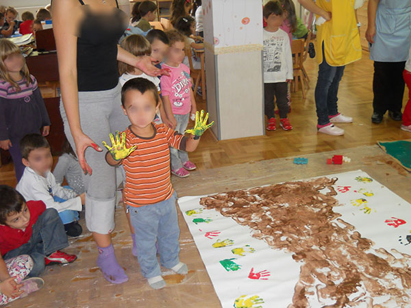 Group of children painting, theme is Spring is here