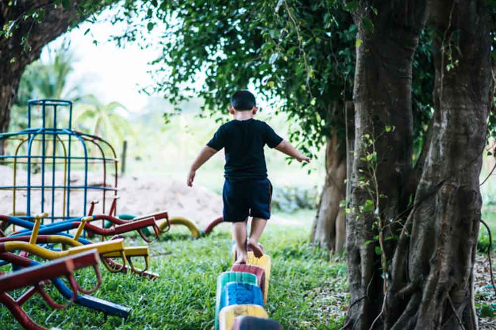 The boy plays on the playground