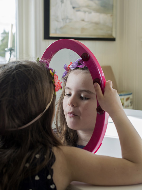 A girl looks in the mirror, photo credit Smengelsrud