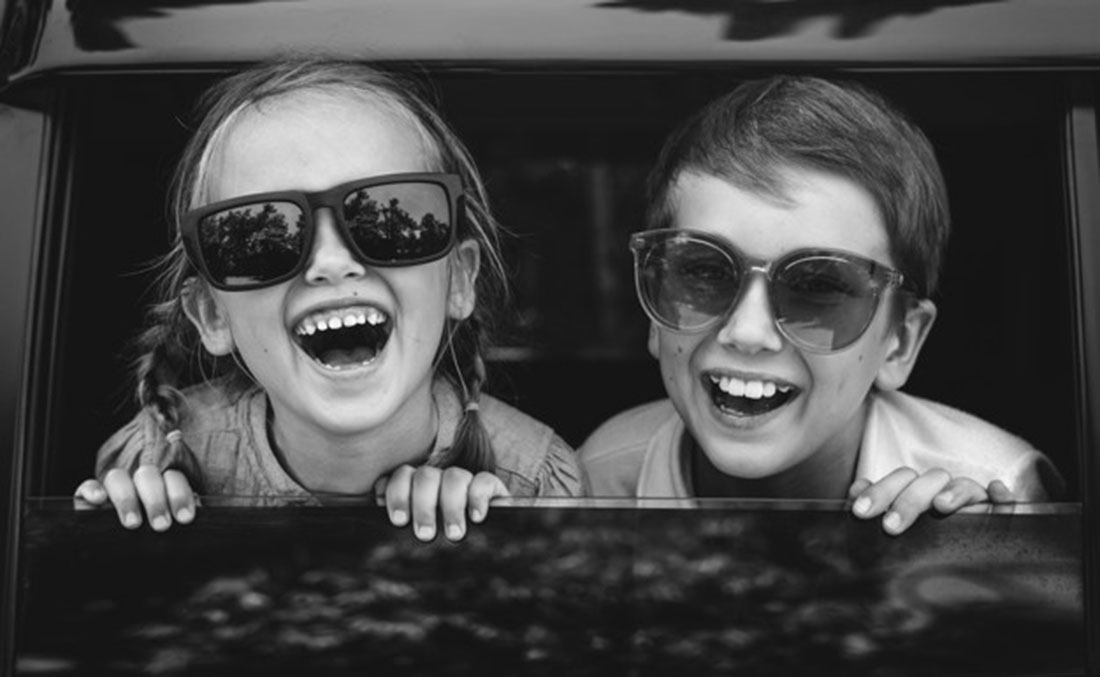 Happy kids looking out the car window