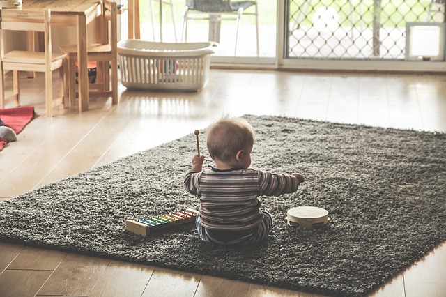 The baby is exploring musical instruments