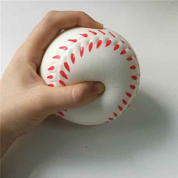 Boy squeezes the soft ball with his hand