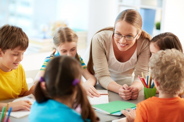 Happy teacher listening her students