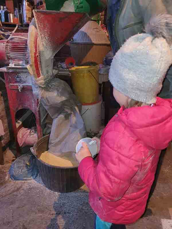 Katarina learned how to work with a corn grinder